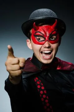 Funny devil against dark background Stock Photos