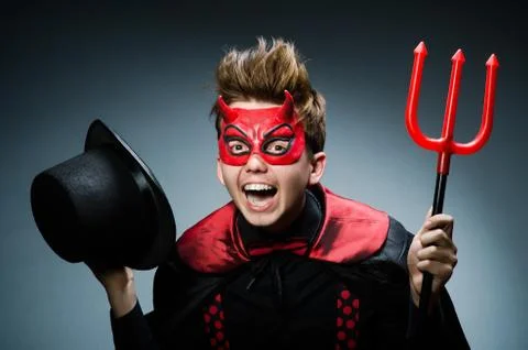 Funny devil against dark background Stock Photos