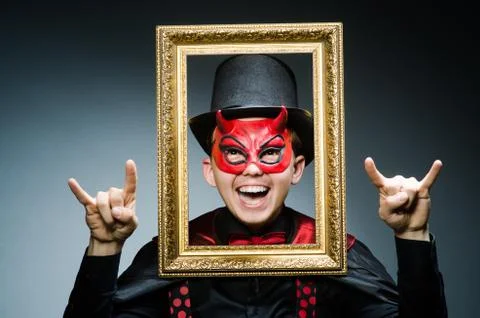 Funny devil with picture frame 스톡 사진