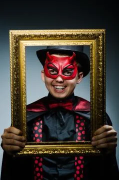 Funny devil with picture frame 스톡 사진