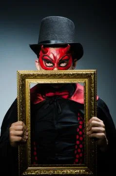 Funny devil with picture frame 스톡 사진