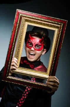 Funny devil with picture frame 写真素材