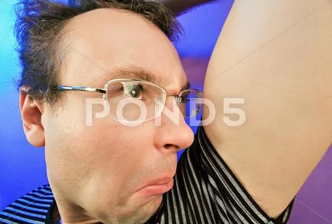 Funny disgusted man in glasses portrait on vivid color background Stock Photos