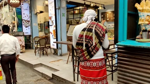 Funny dressed eastern man at the market Stock Footage 156808344