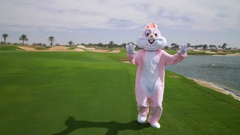 Funny easter bunny or roger rabbit with long ears is waving his hand, walking Видео 108201597