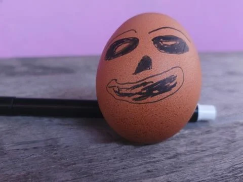 Funny Easter Egg with Hand Drawn Face and Marker Pen on Wood Surface Stock-Fotos