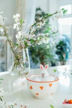Funny Easter eggs containers with bunny ears filled with candy and chocolate in Stock Photos