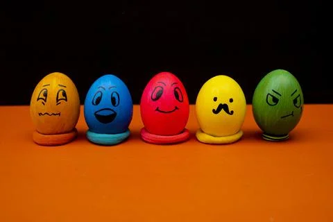 Funny Easter Eggs with Emoji Faces on Orange Surface Stock Photos