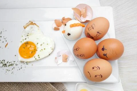 Funny egg faces with daring of sad emotions afraid of cooking Stockfoto's