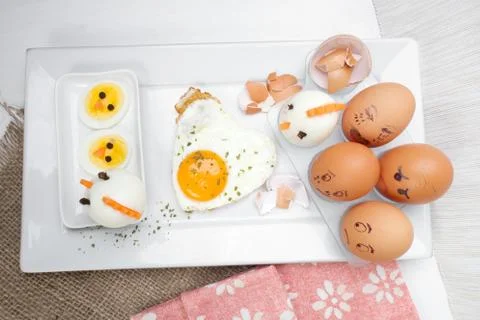 Funny egg faces with daring of sad emotions afraid of cooking Stock Photos