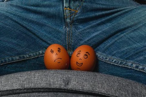 Funny eggs with faces placed on a person's lap Stock Photos