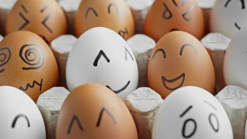 Funny eggs with smiling faces. Happy and unhappy faces. Chicken egg in container Stock Footage 304552534