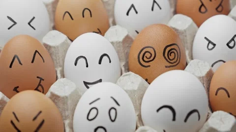 Funny eggs with smiling faces rotating. Chicken eggs in container. Video stock 303703961