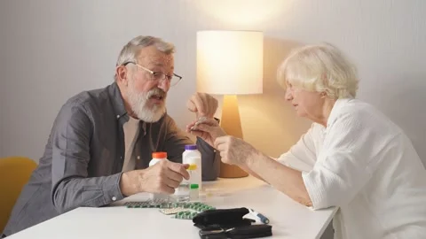 Funny elderly couple arguing over the pills that an elderly man needs to take Video stock 164592060