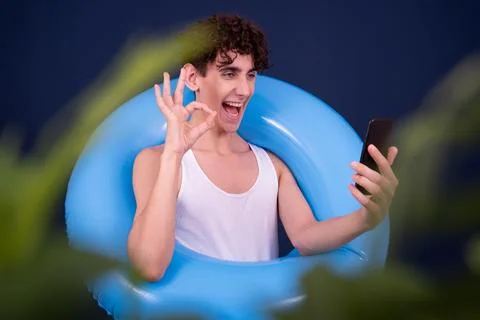 Funny emotions of an attractive guy. Blue background. Stock Photos
