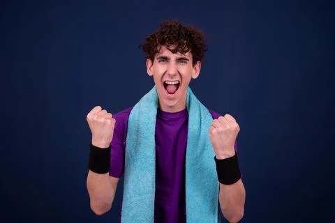 Funny emotions of an attractive guy. Blue background. Stock Photos