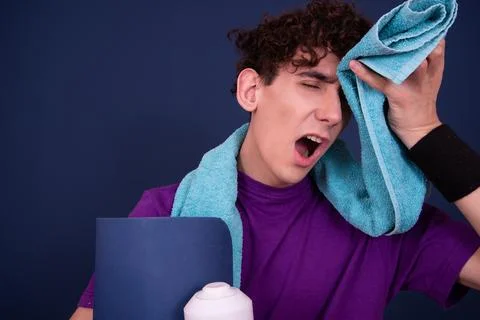 Funny emotions of an attractive guy. Blue background. Stock Photos