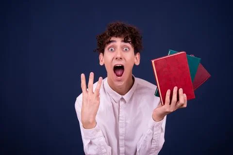 Funny emotions of an attractive guy. Blue background. Stock Photos