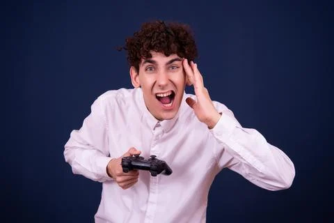 Funny emotions of an attractive guy. Blue background. Stock Photos
