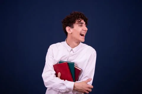 Funny emotions of an attractive guy. Blue background. Stock Photos