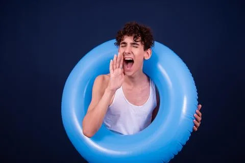 Funny emotions of an attractive guy. Blue background. Stock Photos