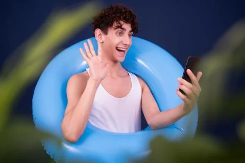 Funny emotions of an attractive guy. Blue background. Stock Photos