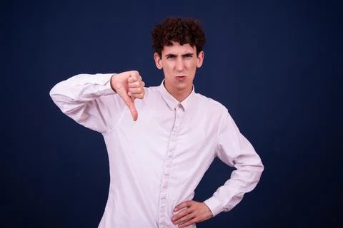 Funny emotions of an attractive guy. Blue background. Stock Photos