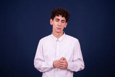 Funny emotions of an attractive guy. Blue background. Stock Photos