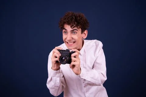 Funny emotions of an attractive guy. Blue background. Stock Photos