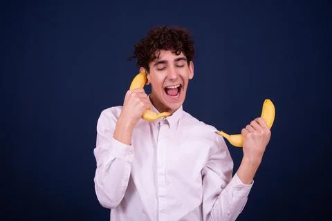Funny emotions of an attractive guy. Blue background. Stock Photos