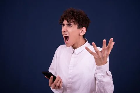 Funny emotions of an attractive guy. Blue background. Stock Photos