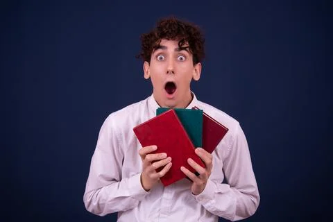 Funny emotions of an attractive guy. Blue background. Stock Photos