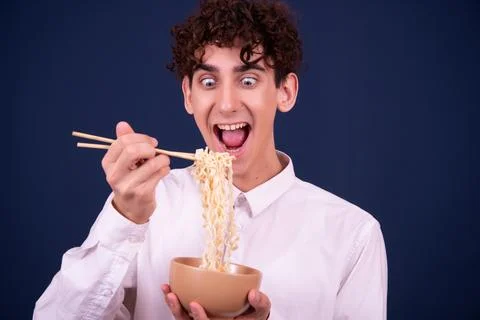 Funny emotions of an attractive guy. Blue background. Stock Photos