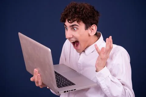 Funny emotions of an attractive guy. Blue background. Stock Photos