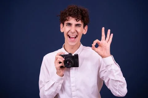 Funny emotions of an attractive guy. Blue background. Stock Photos
