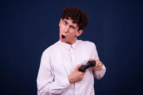 Funny emotions of an attractive guy. Blue background. Stock Photos