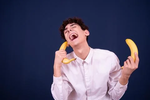 Funny emotions of an attractive guy. Blue background. Stock Photos