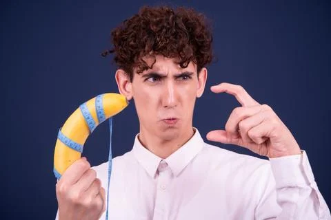 Funny emotions of an attractive guy. Blue background. Stock Photos
