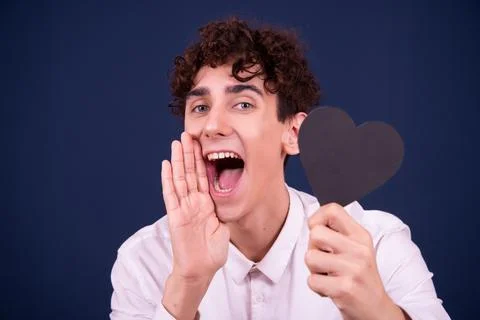 Funny emotions of an attractive guy. Blue background. Stock Photos