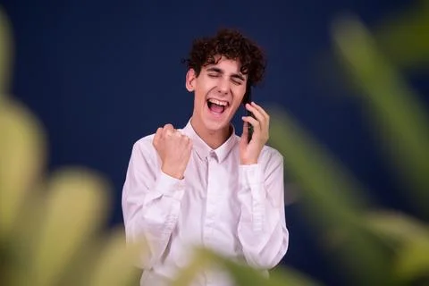Funny emotions of an attractive guy. Blue background. Stock Photos