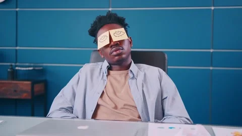 Funny exhausted man sleeping at workplace withdrawn eyes on sticky notes on face Video stock 163440761