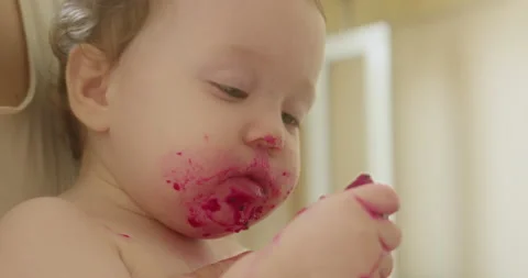 Funny expression emotion face of cute baby girl from eating sour berries Stock Footage 231705310
