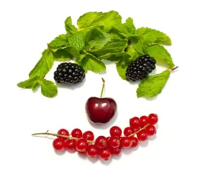 Funny face from different berries on a white background Stock Photos