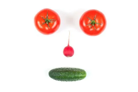 Funny face from different vegetables tomatoes, cucumber, radish, dill and ros Stock Photos
