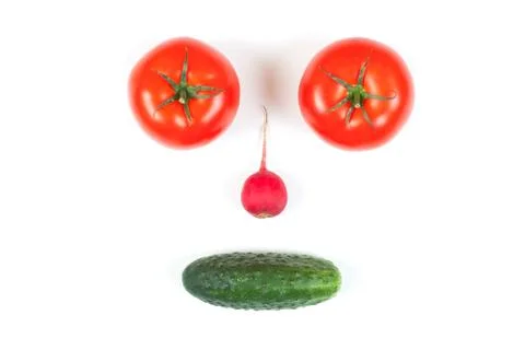 Funny face from different vegetables tomatoes, cucumber, radish, dill and ros Stock Photos