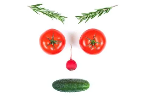 Funny face from different vegetables tomatoes, cucumber, radish, dill and ros Stock Photos