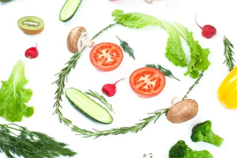 Funny face from different vegetables tomatoes, cucumber, radish, dill and ros Stock Photos