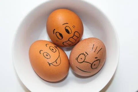 Funny faces drawn on eggs Stock Photos
