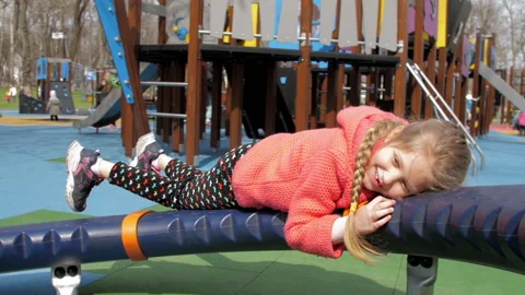 Funny fair haired kid with plait on rotating attraction Stock Footage 154060828