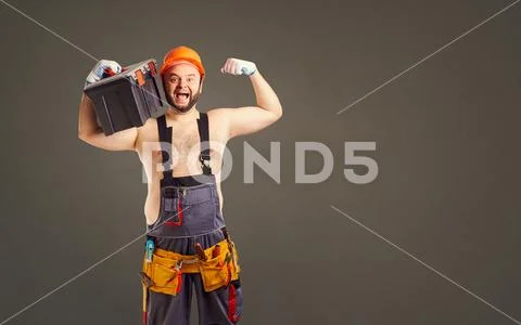 Funny fat bearded builder with a tool box. Stock Photos